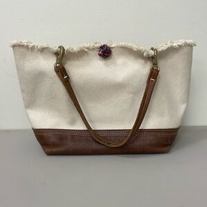 Durable waxed canvas handbag with leather handles and bottom